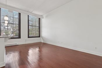 A room with wooden floors and white walls.